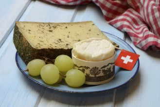 Plate of Swiss cheese, Gstaad mountain cheese with herbs and cream cheese 'Fette Berta',
