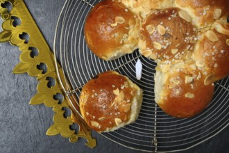 Epiphany cake with paper crown and king, Switzerland