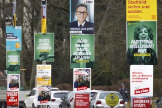Numerous election posters for the 2026 local elections are hanging one behind the other on several