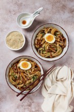 Buckwheat noodles soba with shimeji mushrooms, with boiled egg, green onion, sesame seeds,
