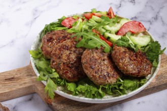 Fried cutlets, mixed minced meat, with vegetable salad, homemade, top view, no people