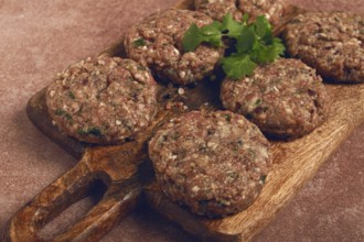 Raw cutlets, minced meat, on a chopping board, homemade, top view, no people