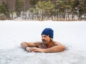 Man with cap, 55, ice bathing in an ice hole, Thumsee, Bad Reichenhall, Berchtesgadener Land, Upper