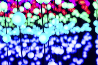 Light, glowing balls, LED lamps, hang in series, side by side, on top of each other, change their