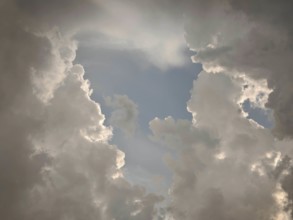 Dramatic cloud formations in the sky allow light to shine through, Germany