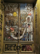 Graffiti-covered door full of tags and colorful colors that show urban art and creative