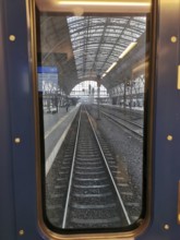 View from train window of abandoned train tracks in the train station, Prague