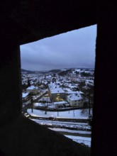 Evening view of snow-covered urban landscape through window, Upper Franconia