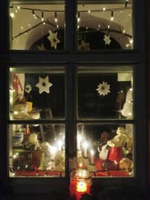 A Christmassy decorated window with atmospheric lighting and garland of lights, Franconian Forest