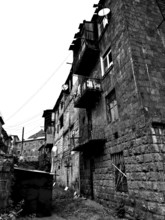 Abandoned street view with old, partly dilapidated buildings in a residential settlement, Alaverdi,