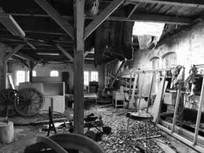 Old abandoned industrial space with visible beams and scattered tools, Franconian Forest