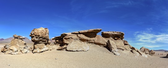 Wide panoramic view of impressive rock formations in the desert under a blue sky, The landscape of