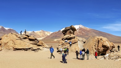 People climb rocks against a majestic mountain backdrop in the desert, The landscape of the