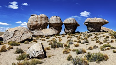 Remarkable rock formations rise in a dry desert landscape under clear skies, The landscape of the