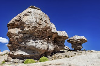 Impressive rock formations rise in a vast desert landscape under blue skies, The Landscape of the
