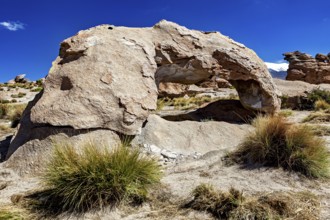 Natural stone arch in a dry desert landscape under bright blue sky, The landscape of the Altiplano