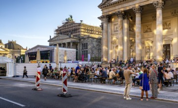 Listeners and spectators at a concert at Berlin's Gendarmenmarkt, Germany