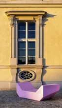 Pink and red plastic furniture for sitting and lying in front of the Humboldt Forum, Berlin,