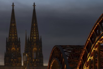 Evening atmosphere, Cologne Cathedral illuminated with LED lamps and the Hohenzollern Bridge,