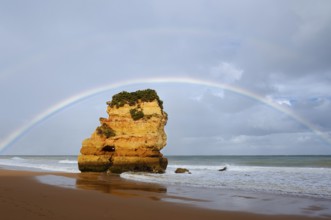 Rocks on beach with rainbow, Praia Dona Ana, Lagos, Algarve, Portugal