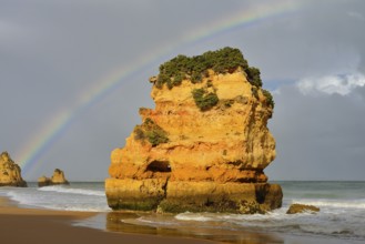 Rocks on beach with rainbow, Praia Dona Ana, Lagos, Algarve, Portugal