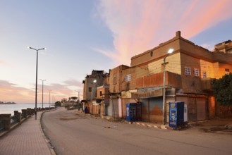 Street and houses on the Nile at dawn, Esna, Egypt