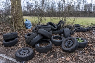 Illegally disposed of car tires and other trash, on a side street in Duisburg-Kaiserberg, North