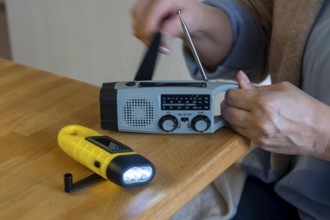 Emergency equipment, flashlight and radio with crank operation, by turning the crank we generate