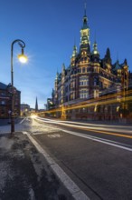 Speicherstadtrathaus in Speicherstadt with road traffic at the blue hour, Hamburg, Germany