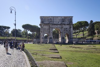Arch of Constantine with tourists on sunny day, Lazio, Italy