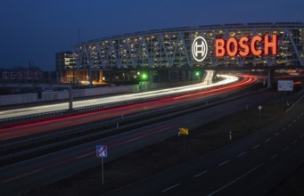 Traffic on the A8 motorway, blue hour, illuminated parking garage, Landesmesse Stuttgart, red-lit