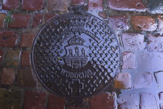 Manhole cover with the coat of arms of Krakow, Krakow, Poland