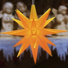 Glowing Christmas star in front of angel figures at the Christmas market, detail, Paderborn,