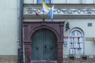 Historic entrance portal with a relief of a bookshelf, Krakow, Poland