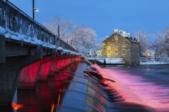 Illuminated Moulin Neuf water flow control dam and walkway over Des Mille-Iles river plus New Mill