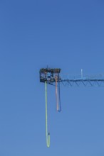 Montreal Bungee Tower installation with dangling long yellow elastic bungee jumping cord and woman