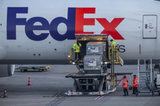 FedEx Express Boeing 777-FS2 cargo plane is unloaded, air freight container, air freight center at