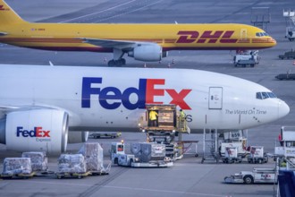 FedEx Express Boeing 777-FS2 cargo aircraft air freight containers are unloaded, DHL Boeing 757-200