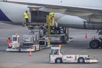 FedEx Boeing 777-FS2 cargo plane is unloaded, air freight container, air freight center at
