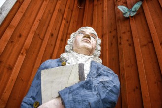 Wooden statue of botanist and founder of the binary nomenclature Carl von Linné with white hair and