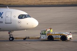 Lufthansa City Airbus A320neo is pushed from the gate onto the taxiway, ready to go, to