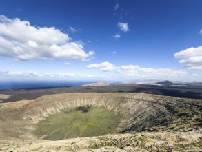View of the Caldera Blanca volcano cauldron against blue sky with white clouds, Mancha Blanca,
