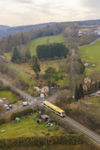 Rural scene with yellow train in green countryside and scattered houses, acceptance of the Hermann