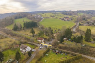 Aerial view of a rural area with trains, fields and small villages in the background, departure of