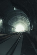 View through a dark tunnel with light at the end. Atmospheric and deserted, acceptance of the