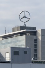 Industrial building with Mercedes-Benz logo on the roof under cloudy sky, Mercedes Star,
