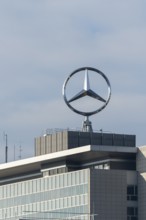 Mercedes-Benz logo over a modern building with blue sky, Mercedes Star, Stuttgart-Untertürkheim,