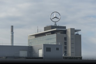 Industrial building with Mercedes logo under a cloudy sky, Mercedes Star, Stuttgart-Untertürkheim,