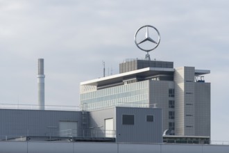 Modern industrial complex with Mercedes-Benz logo and cloudy sky, Mercedes Star,