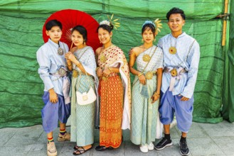 A group of young people wearing traditional clothing presents themselves for the photographers, Wat